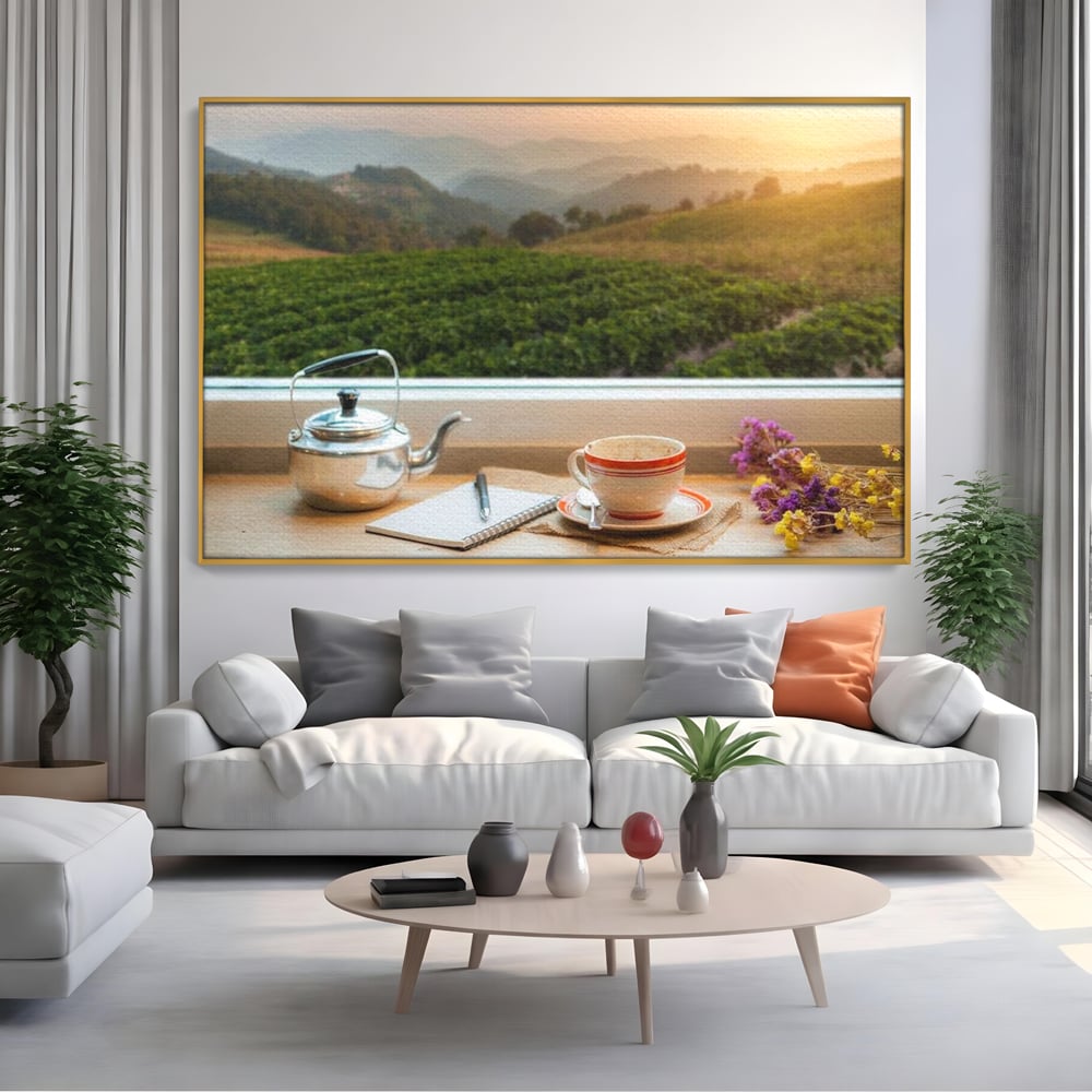 Tablou canvas cu tablou canvas cu peisaj matinal si ceainic pe pervaz, in rama de aluminiu auriu, pe perete intr-un living